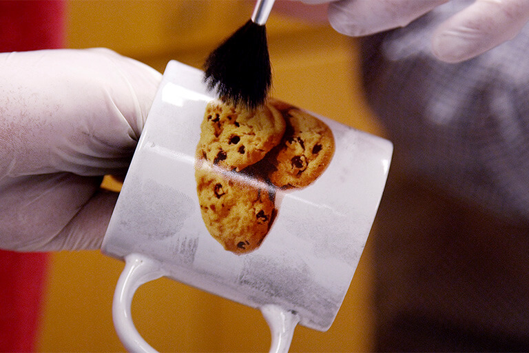 dusting fingerprints off cup