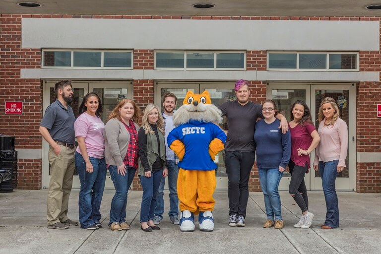 pathfinder posing with a group of students